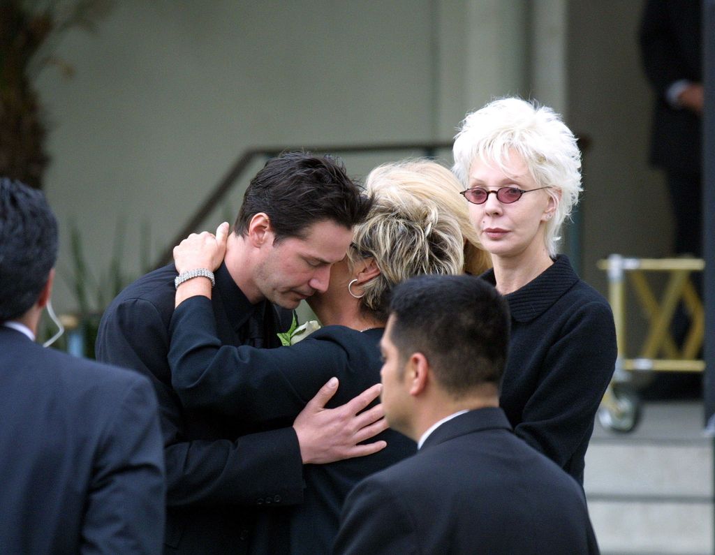 Keanu Reeves and Patricia Taylor are seen at the funeral of Jennifer Syme in 2001
