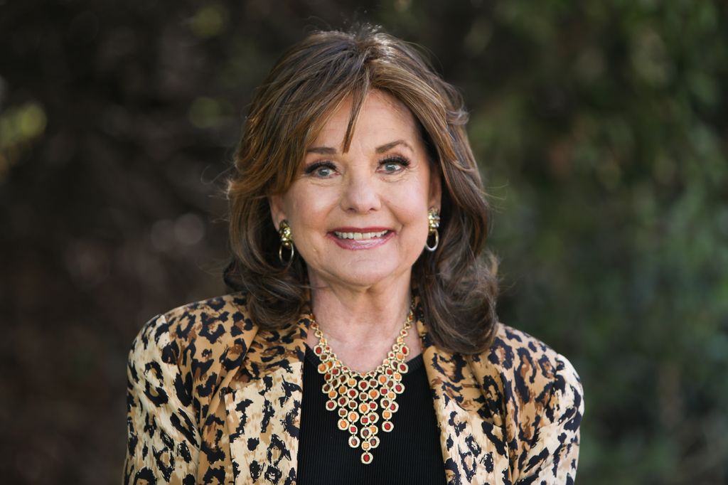 Dawn Wells smiling in a leopard coat