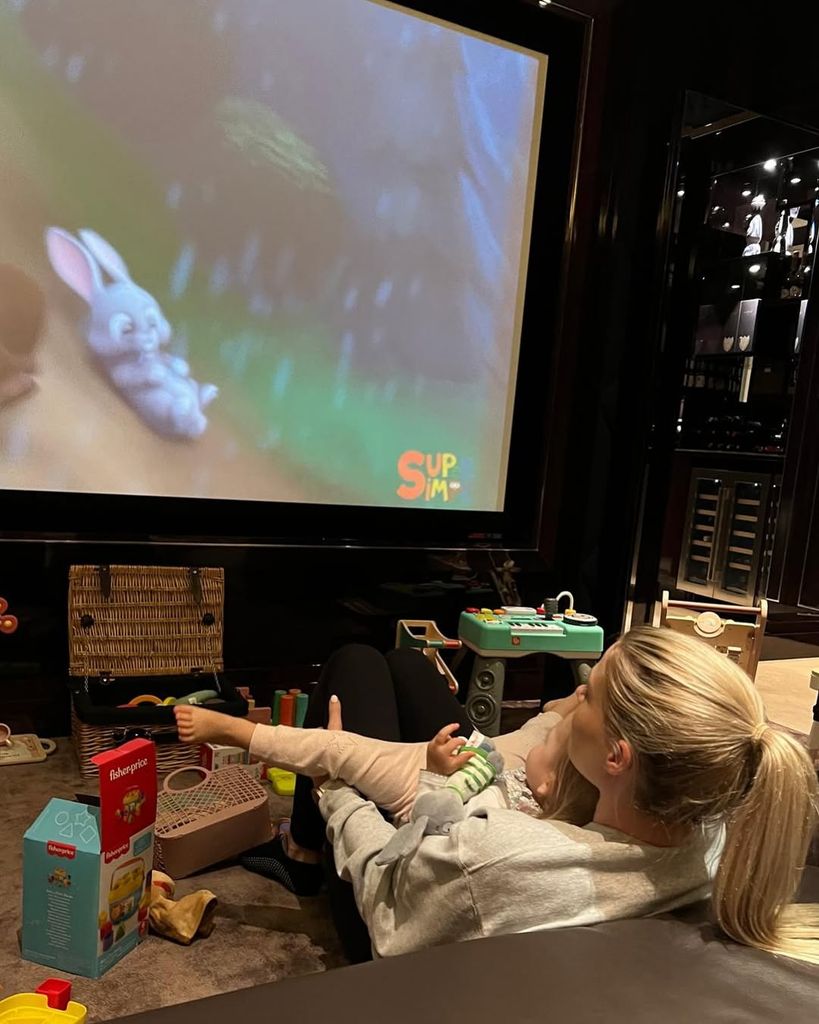 Lady Amelia Spencer holding her niece Athena in Lady Kitty Spencer's cinema room