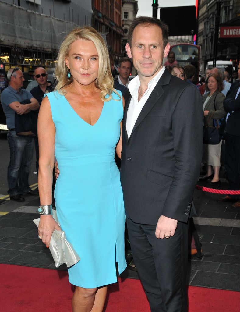 woman and man posing for photo on red carpet