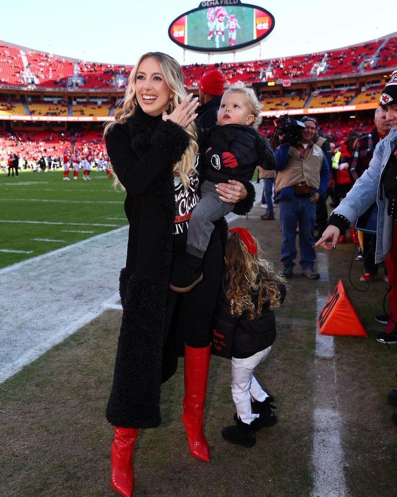 Brittany, pregnant with her third child, wore bright red boots to the game