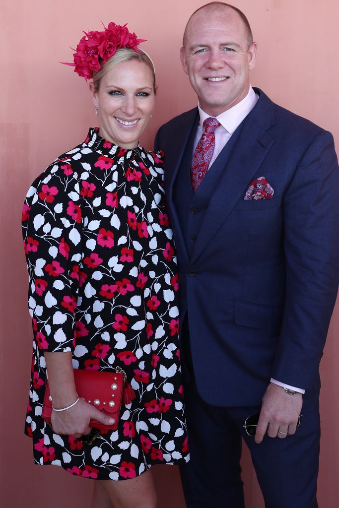Zara Tindall in a floral dress with husband Mike Tindall against a pink backdrop