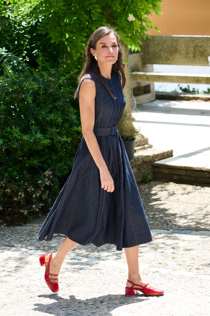 Queen Letizia wearing denim dress and red shoes