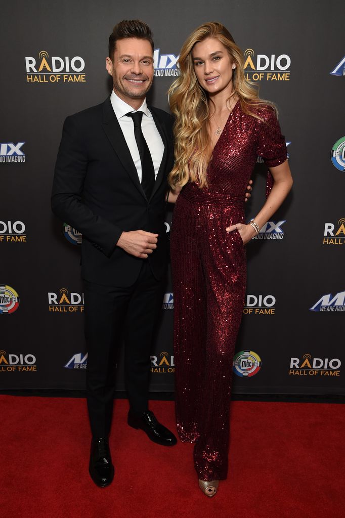 Ryan and Shayna smiling on red carpet in black tie