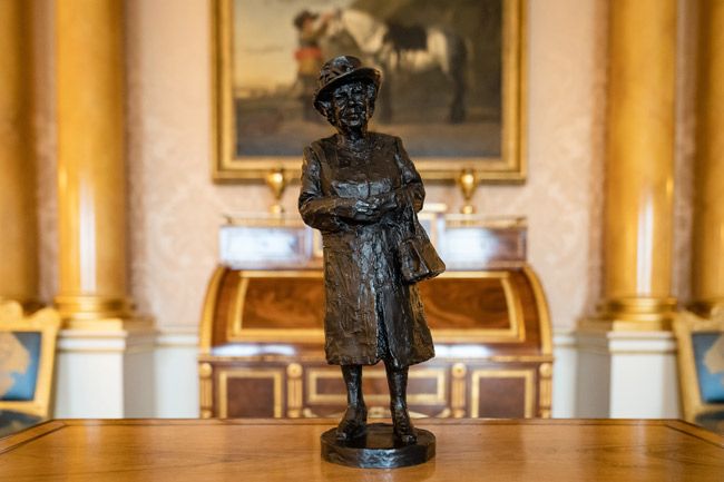 small statue of the queen on table at buckingham palace 