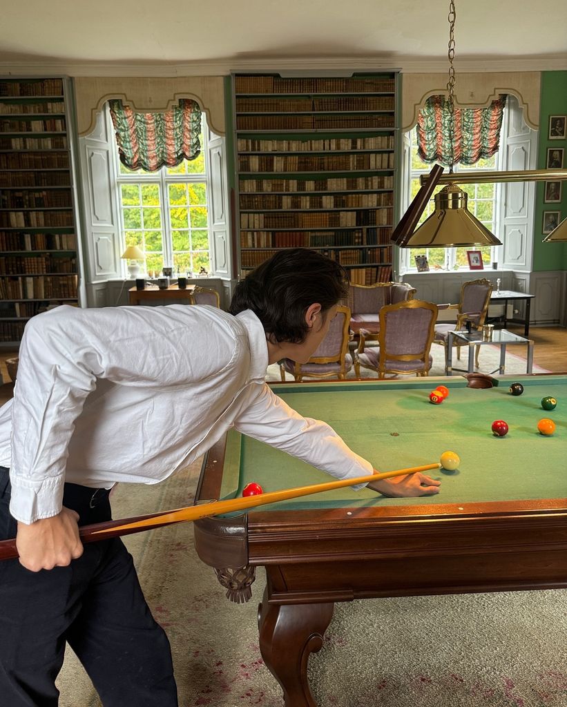 Count Nikolai playing pool in the library at Schackenborg Castle