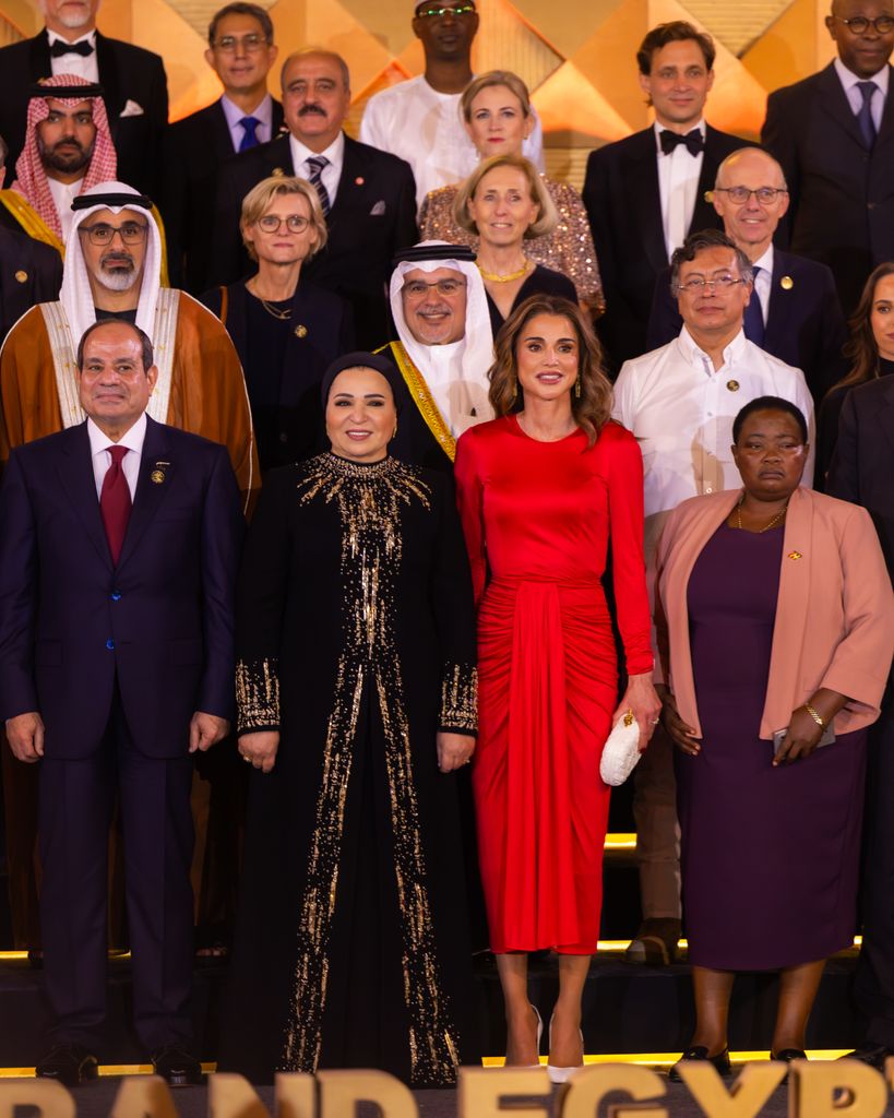 Queen Rania and Princess Salma in group photo surrounded by people