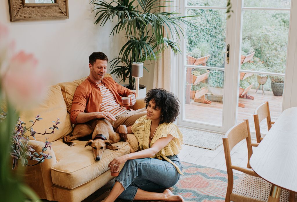 couple on sofa with dog 