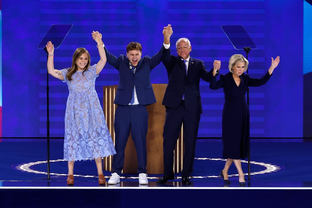 Democratic vice presidential nominee Minnesota Gov. Tim Walz celebrates with his daughter Hope Walz (L), son Gus Walz (2nd-L) and wife Gwen Walz (R) 