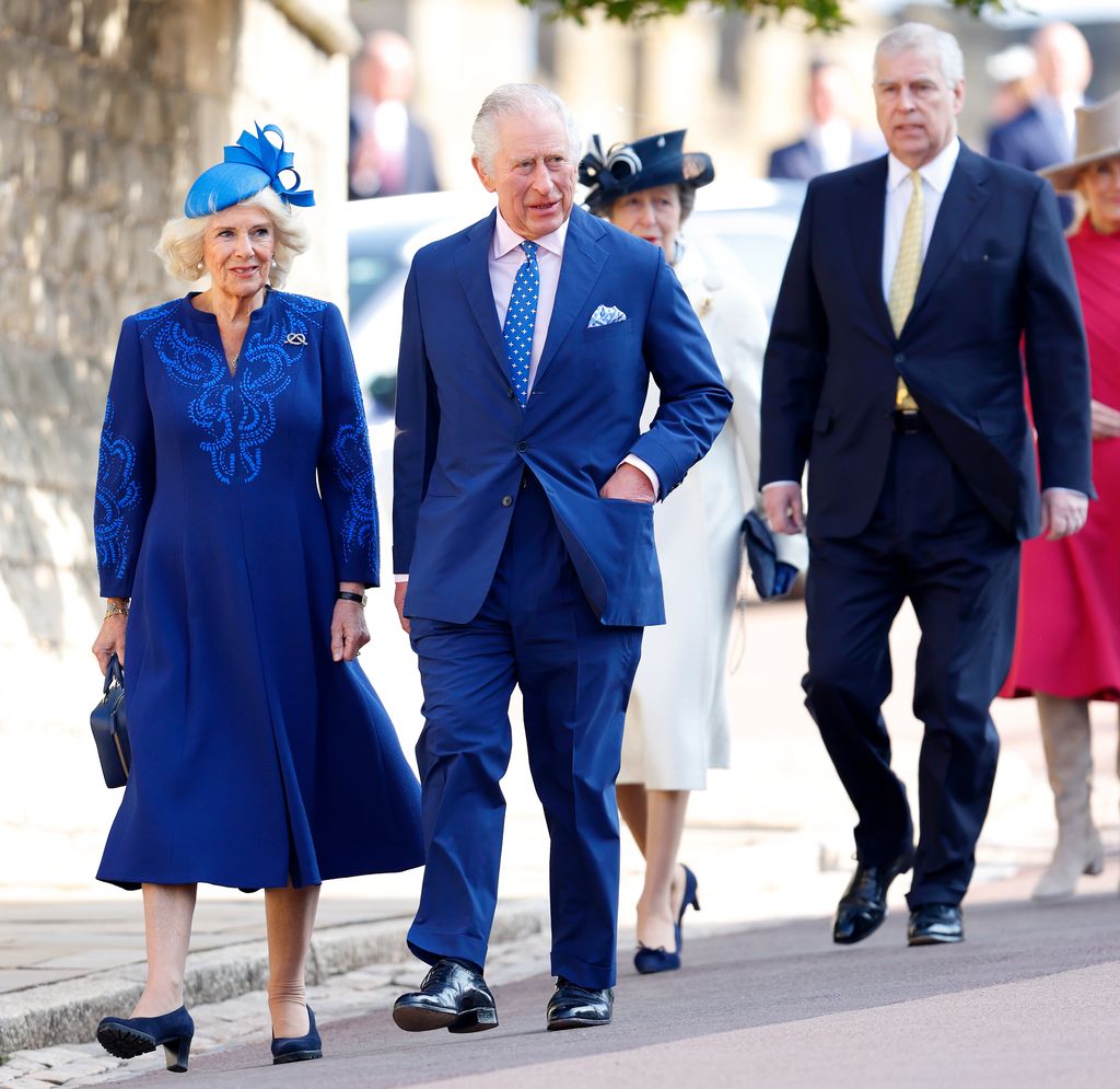 King Charles walking with Queen Camilla; Prince Anne and Prince Andrew are behind them