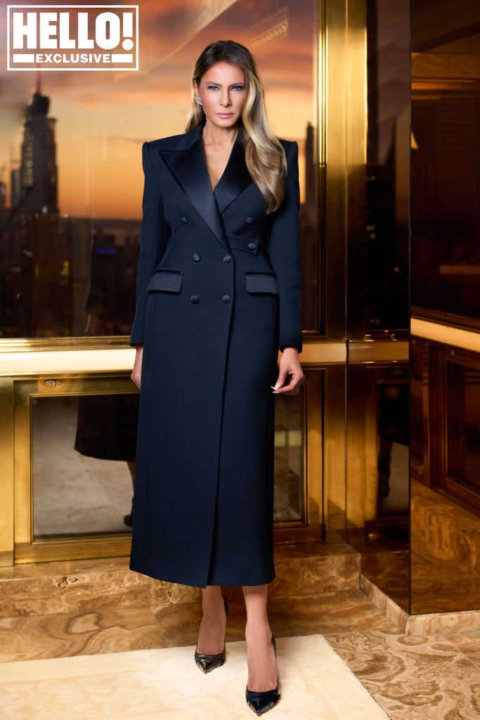 Melania Trump posing in a long black coat