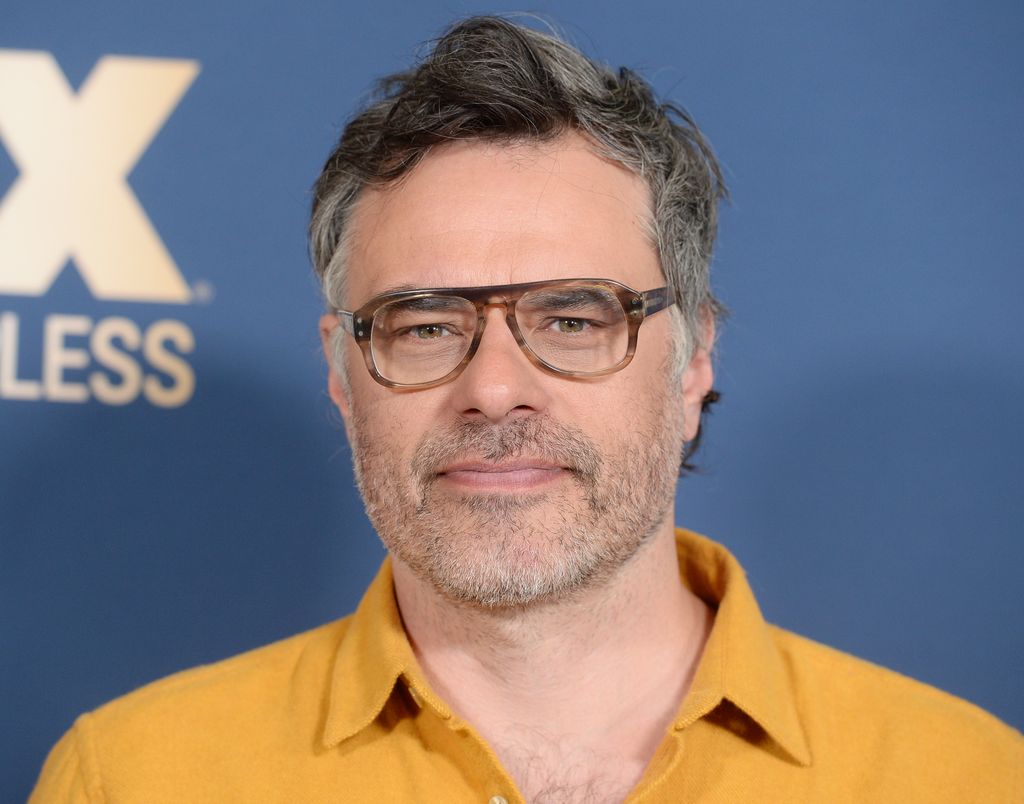 close-up man in glasses in yellow shirt