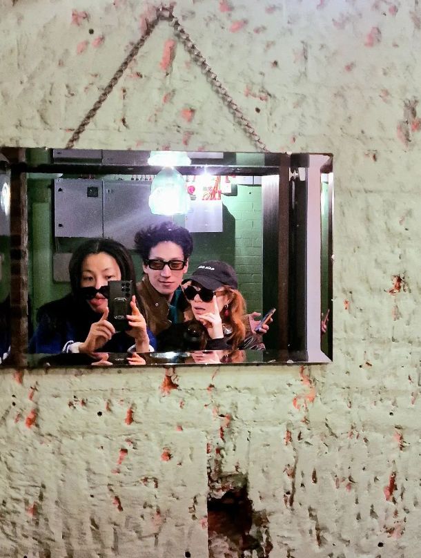 Nancy Xu, Carlos Gu and Angela Scanlon posing in a mirror