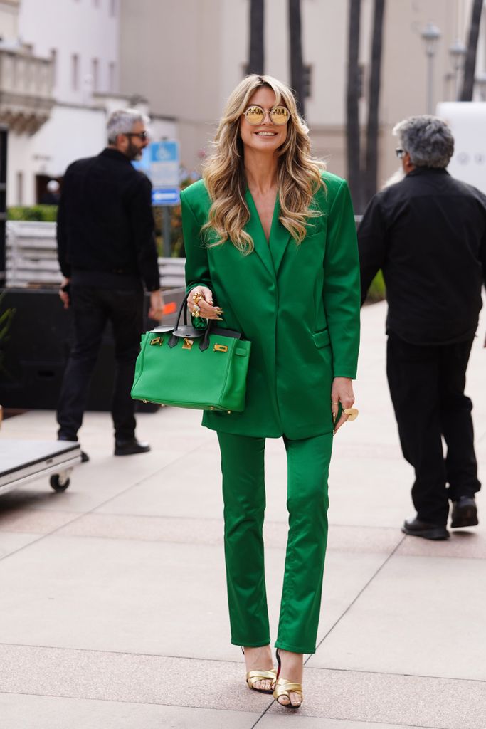 Heidi in an emerald green suit