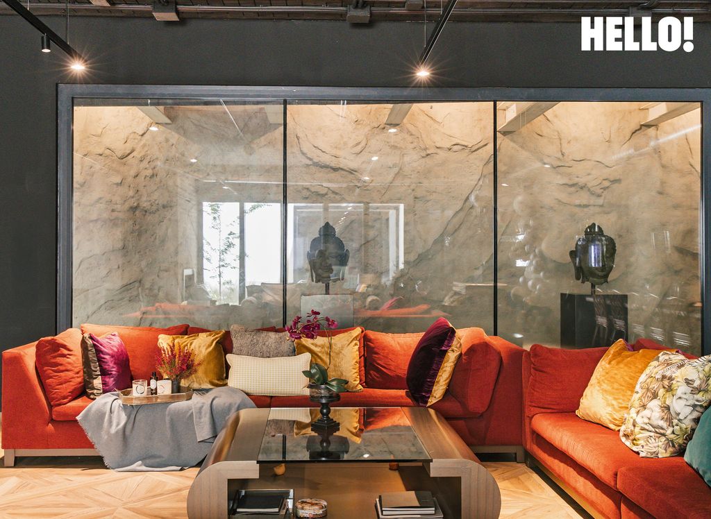 One of the living rooms with a glass panelled wall inside their three-storey, contemporary-style house