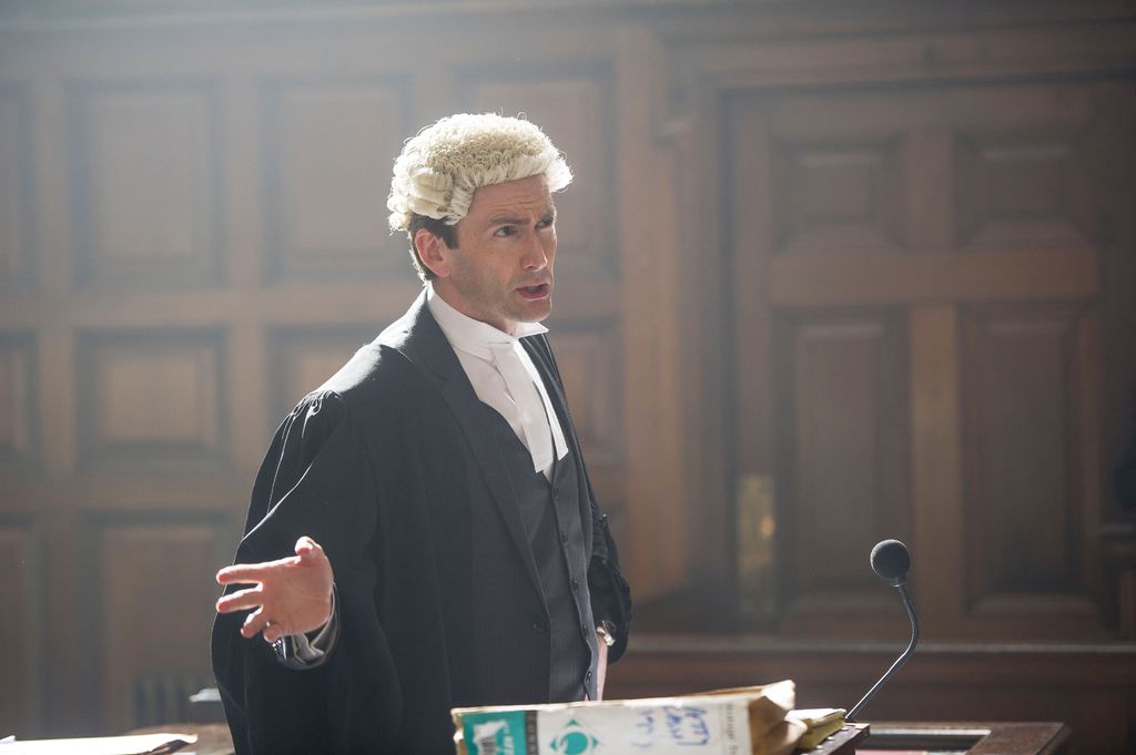 barrister speaking on stand in courtroom