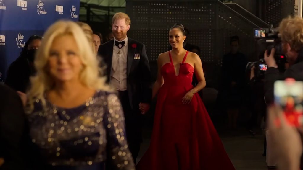 Meghan Markle in a red dress with Prince Harry in 2021