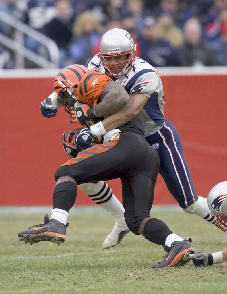 Rodney Harrison #37  of the New England Patriots tackles Rudi Johnson #32 of the Cincinnati Bengals at Gillette Stadium on December 12, 2004 in Foxborough, Massachusetts. The Pats defeated the Bengals 35-28.
