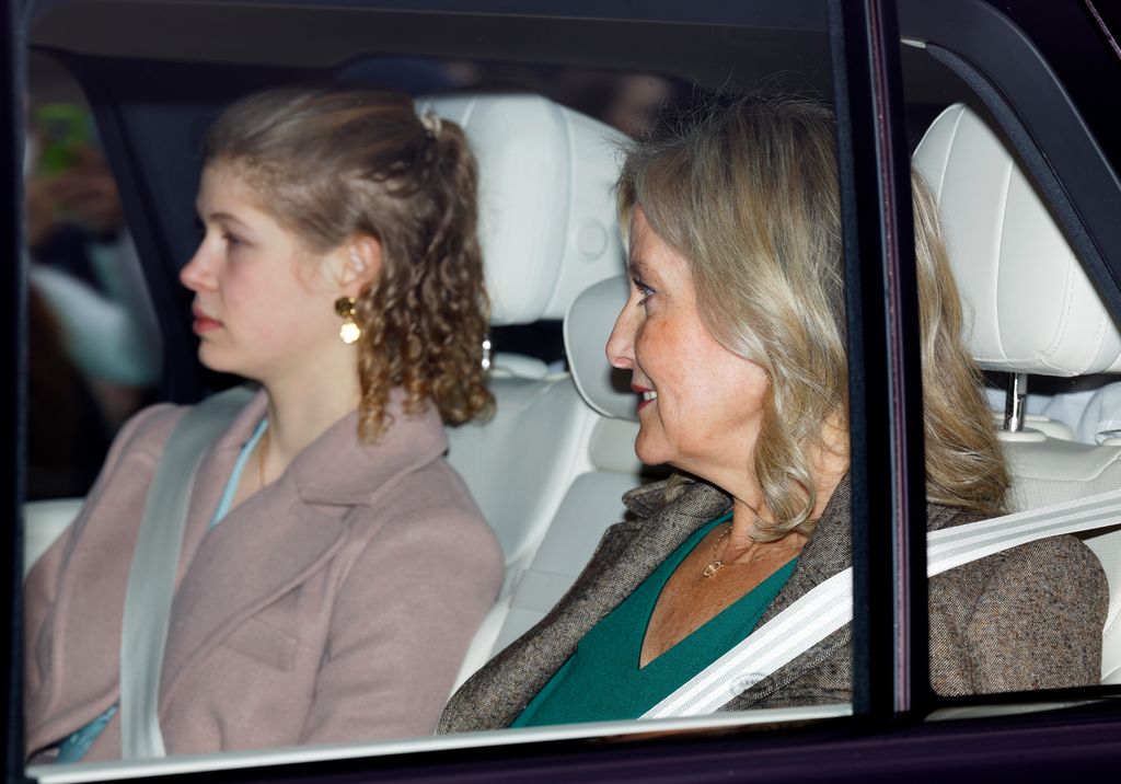 Sophie, Duchess of Edinburgh in green dress and grey coat in car with her daughter, Lady Louise in pale pink coat 