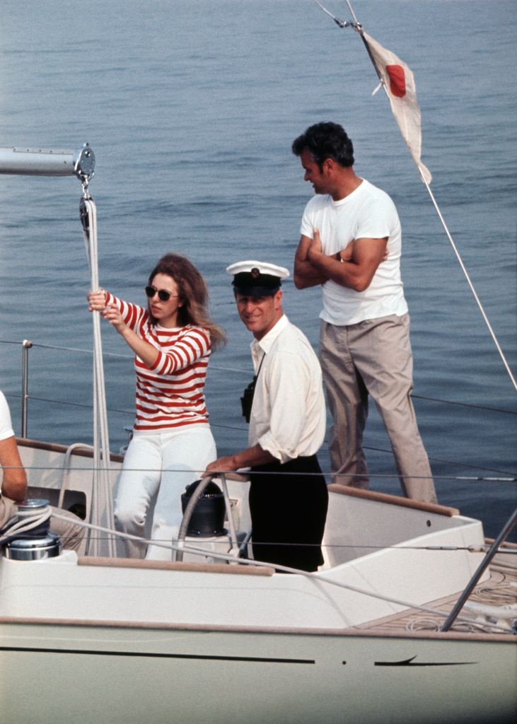 Princess Anne in red and white striped top sailing with Prince Philip