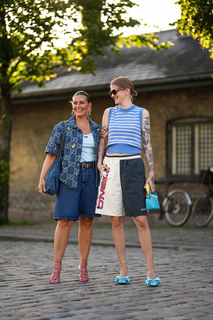 Janka Polliani wore denim knee shorts , a denim logo shirt and crystal earrings, while friend Marianne Theodorsen wore sporty O'Neil shorts and a blue and white striped top in Copenhagen. 