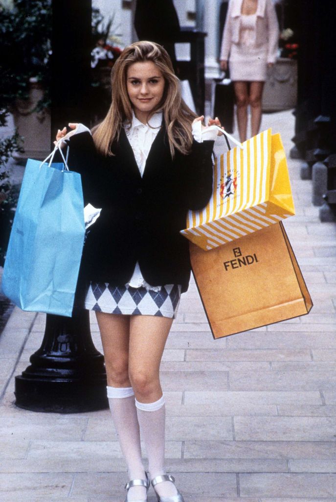 cher in clueless holds shopping bags