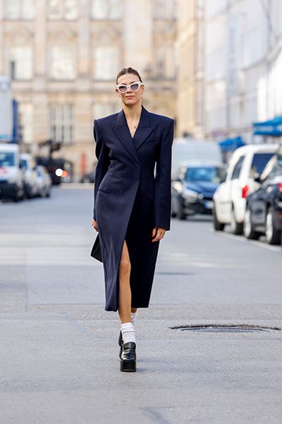 Woman Wearing Heeled Loafers With A Tailored Coat Dress