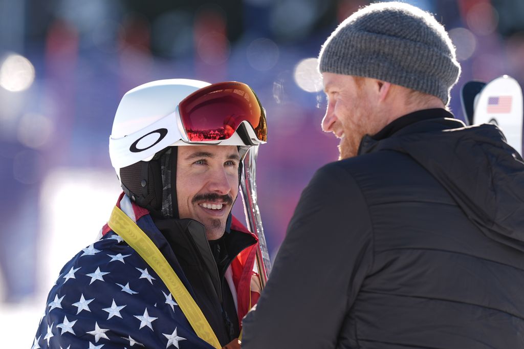 The Duke of Sussex presents the first place gold medal to a US competitor at the Alpine Skiing and Snowboarding Novice Finals