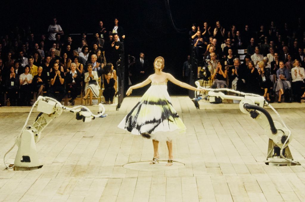 Shalom Harlow is sprayed with paint by robots during the finale of the Alexander McQueen Spring/Summer 1999 