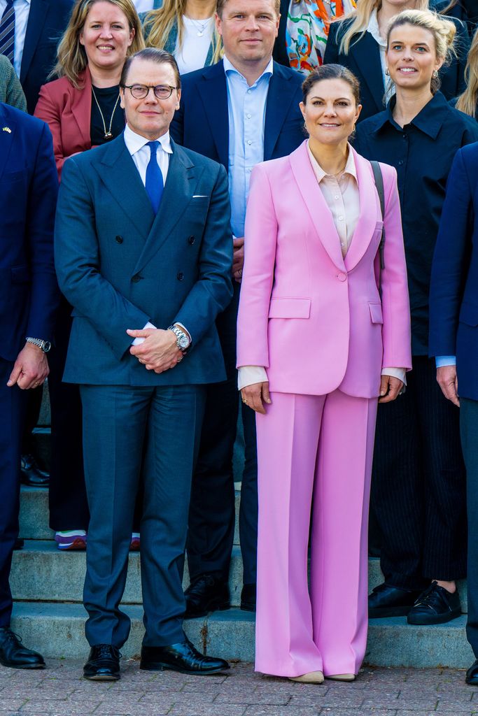 Victoria in pink suit with daniel and others