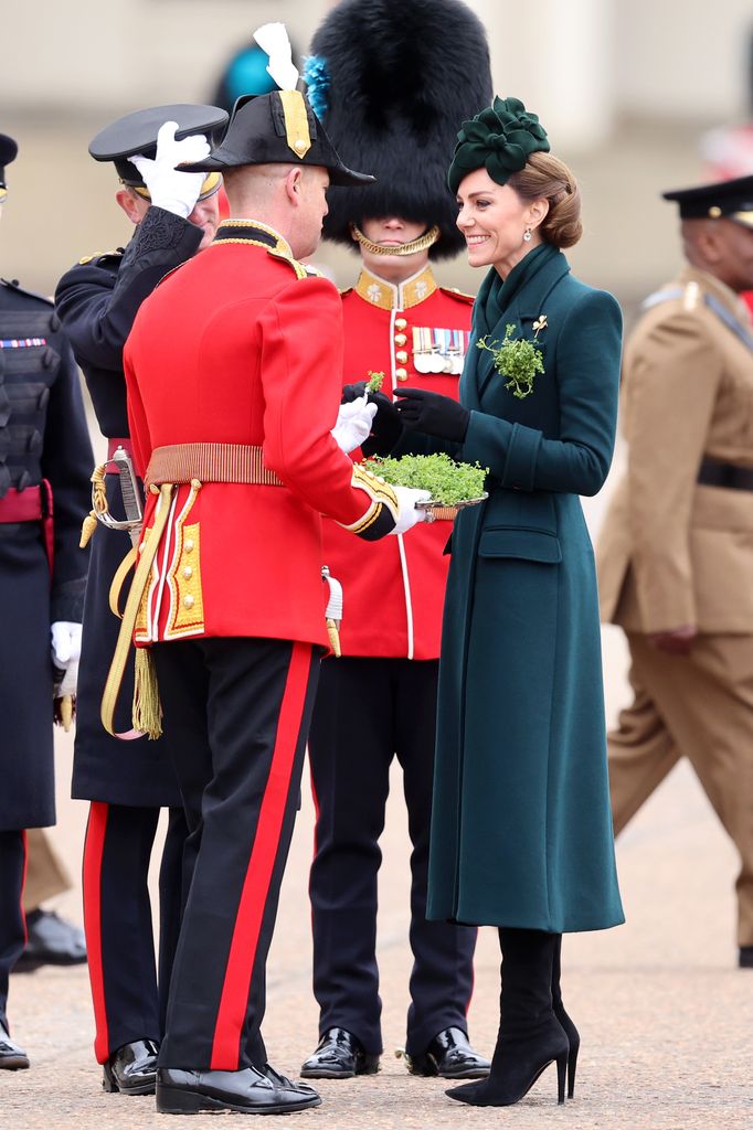 Kate presents traditional sprigs of shamrock to a member of the Irish Guards