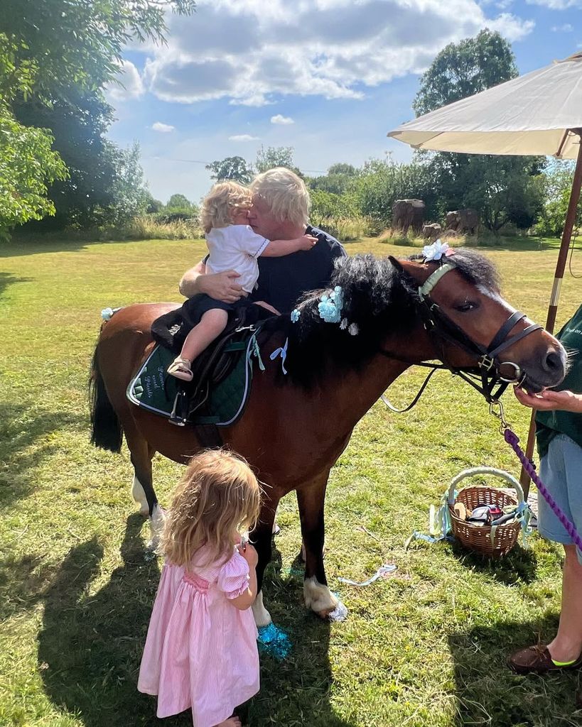 Carrie Johnson's son Frankie on a horse cuddling Boris Johnson