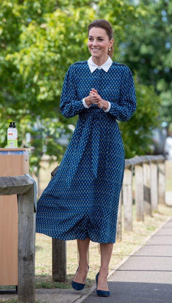 Catherine, Duchess of Cambridge claps in blue printed dress