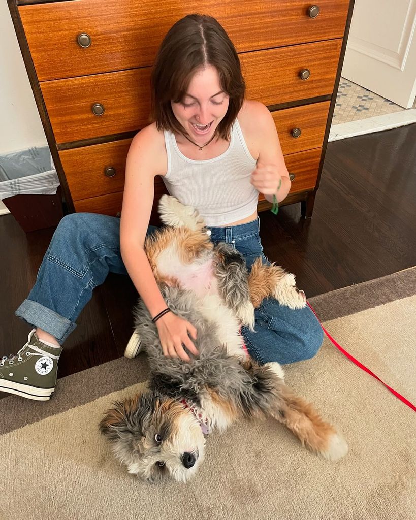 Esmé Annabelle Fox plays with a dog in her home, shared by Michael J. Fox on Instagram