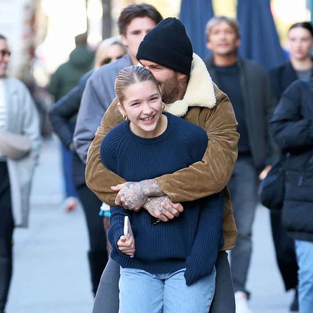 David Beckham hugging Harper Beckham from behind