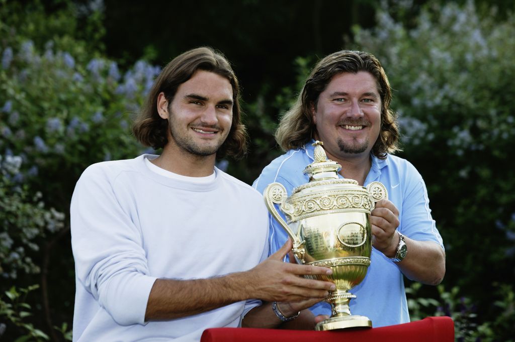 Roger Federer and Peter Lundgren holding the Wimbledon trophy