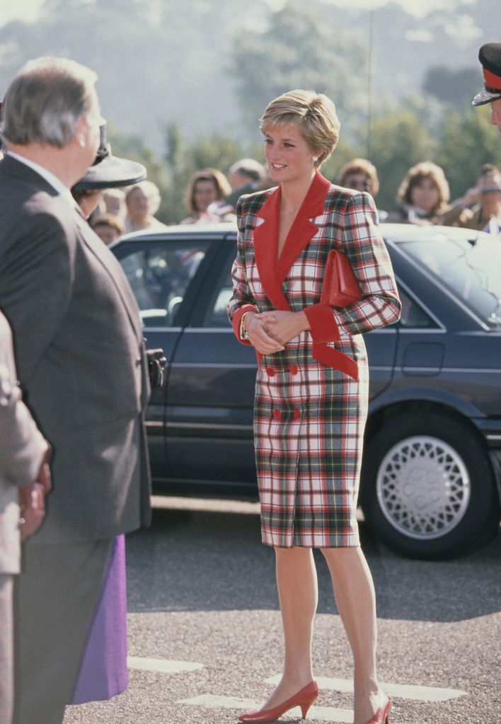 Princess Diana looked resplendent in a tartan coat-dress by Catherine Walker during a visit to Devon 