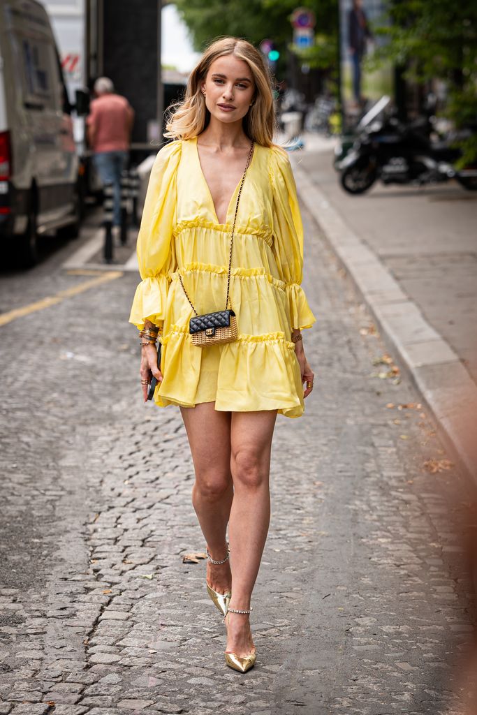 PARIS, FRANCE - JULY 05: Victoria Magrath wears a yellow ruffle mini dress, gold heels and leather and rafia Chanel mini bag, outside Viktor & Rolf, during the Haute Couture Fall/Winter 2023/2024 as part of  Paris Fashion Week on July 05, 2023 in Paris, F