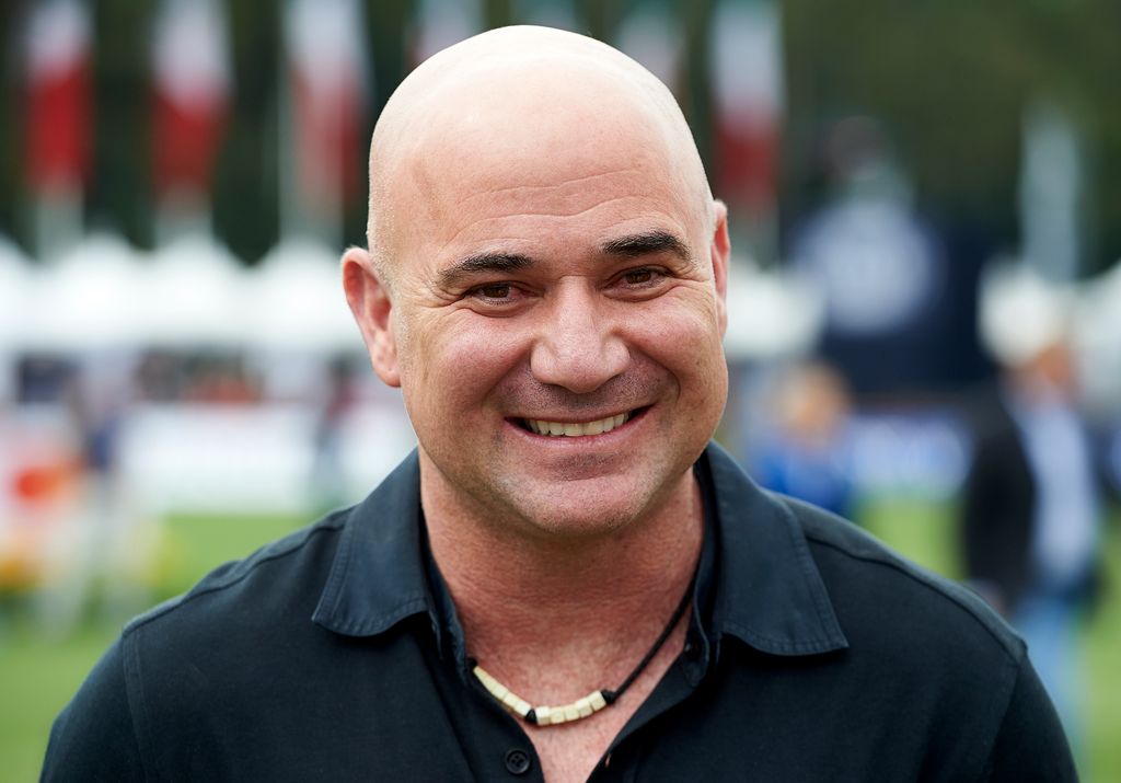 Andre Agassi smiling in black top 