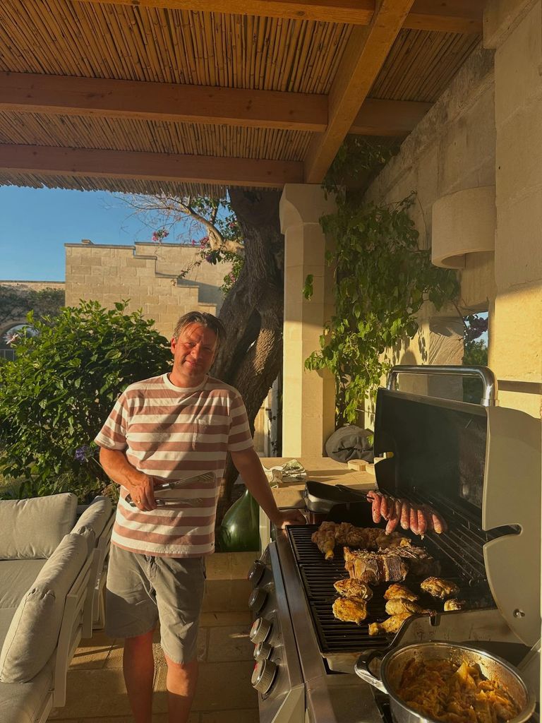 Jamie standing by BBQ