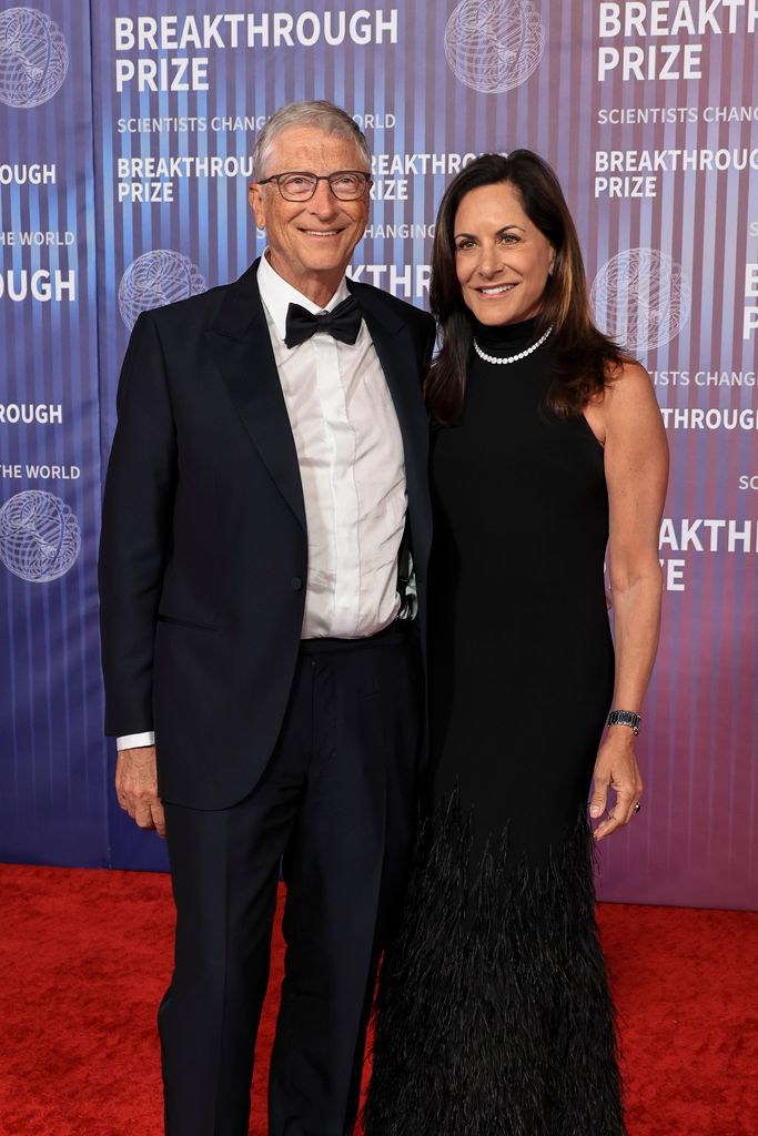 Bill Gates in a black tuxedo and Paula Hurd in a black dress