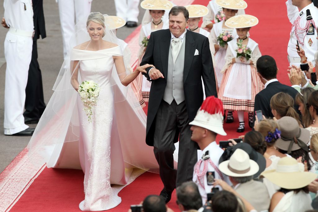 Princess Charlene walking down the aisle with her father Mike Wittstock