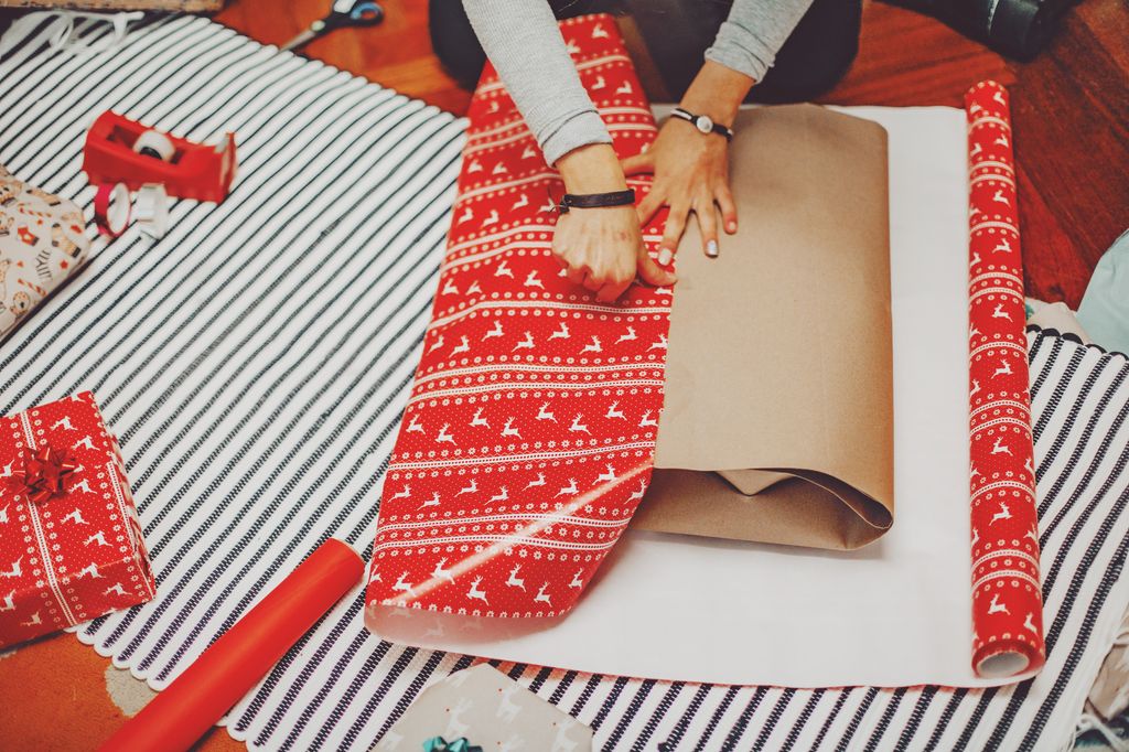 closeup image woman wrapping gifts