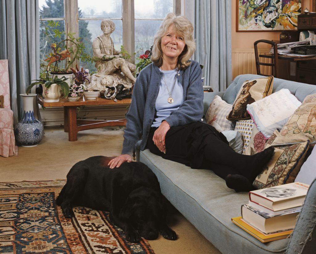 English author Jilly Cooper with a pet labrador at her home in Bisley, Gloucestershire, 4th February 2000. 