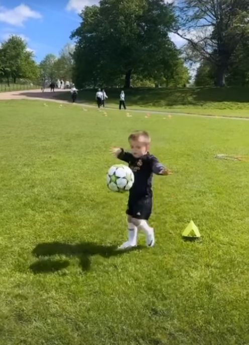 A young boy playing football