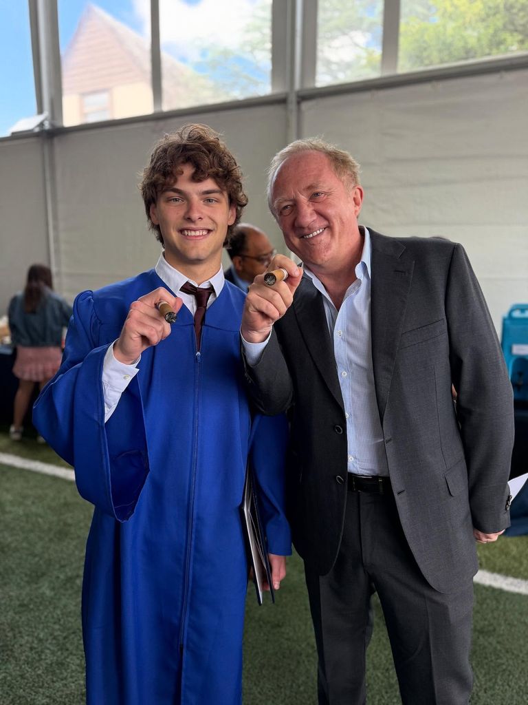 Augustin and his dad with cigars