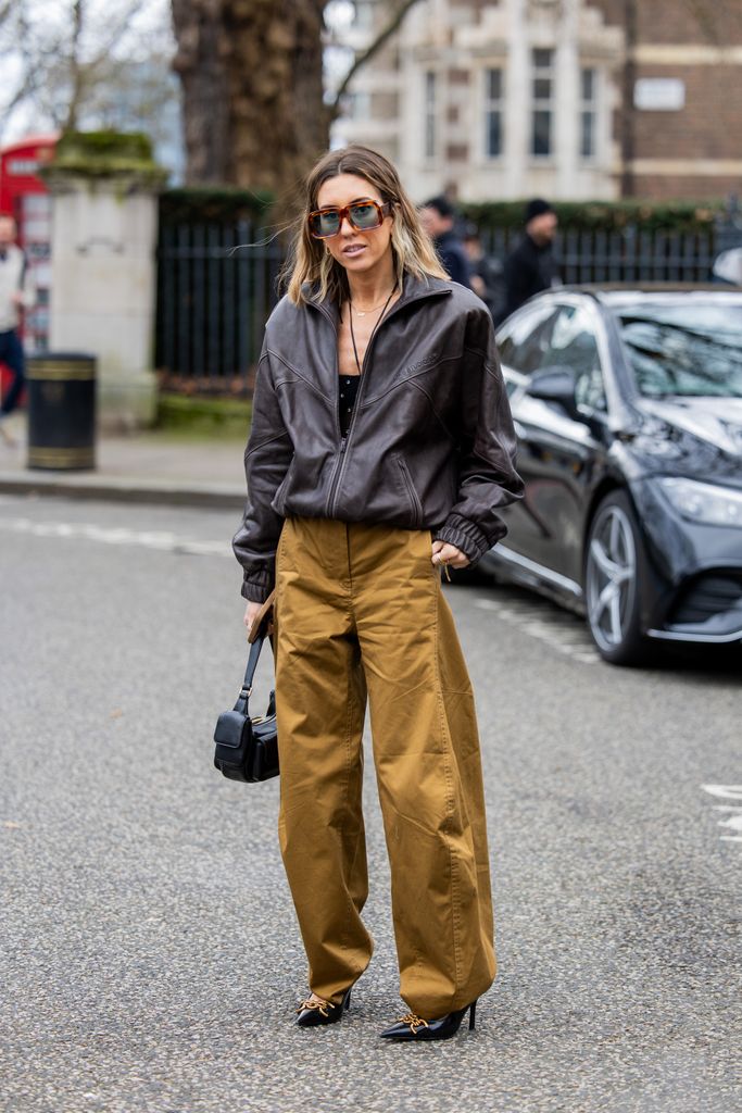 Hannah Lewis elevated street wear in her brown leather bomber, khaki utility trousers and vertiginous heel outside the Roksanda show.