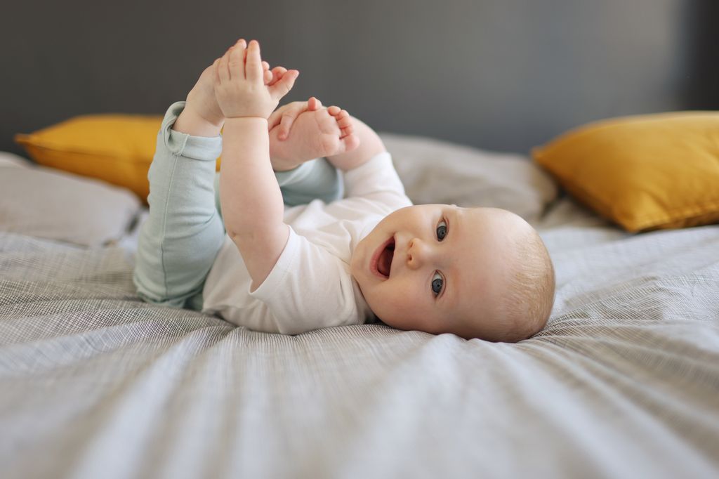 baby lying on bed