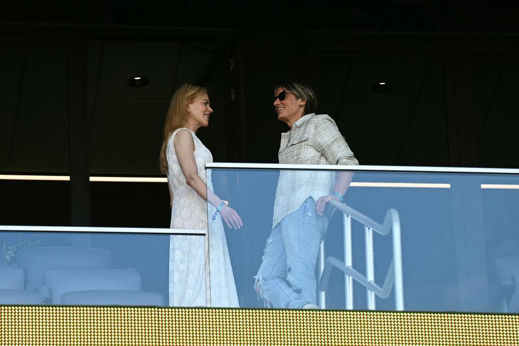 keith urban and nicole kidman talking in box at soccer game