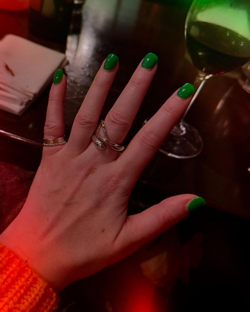 photo of hand with green nails